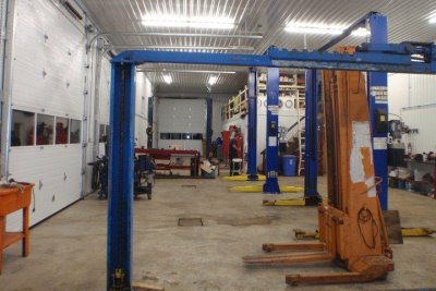 Service bays with blue lifts inside RT Automotive