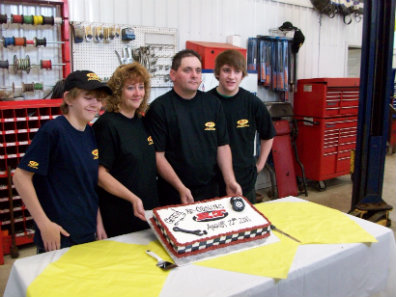 The RT Automotive family team in the shop celebrating an anniversary