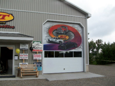 RT Automotive storefront with a painted mural on the garage door
